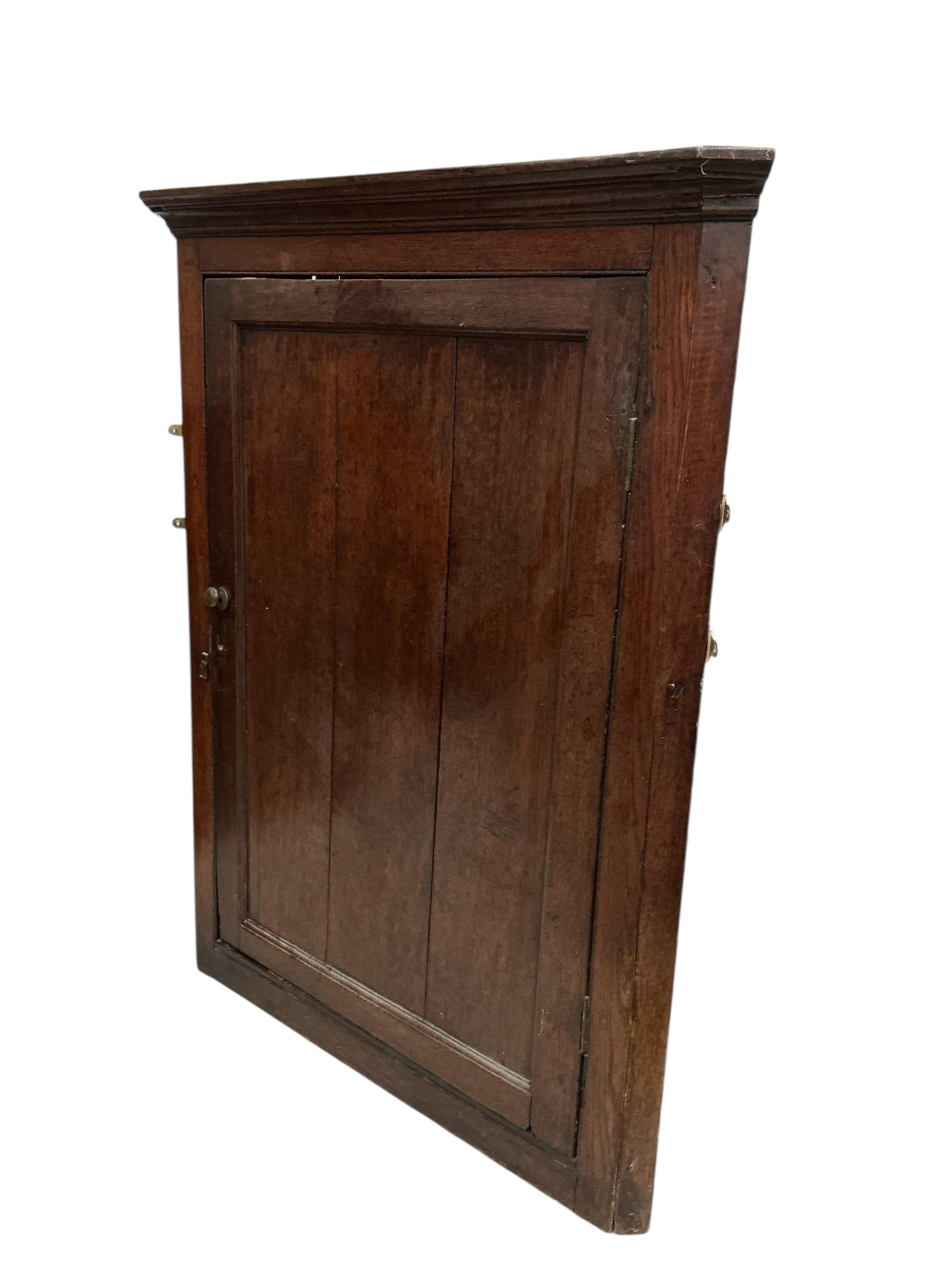 Two George III oak hanging corner cupboards, largest width 102cm, depth 48cm, height 128cm